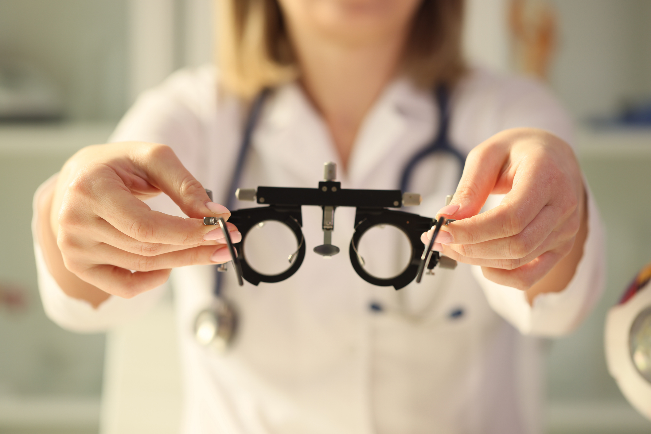 The optometrist holds a frame for the selection of lenses, a close-up. Ophthalmological study, astigmatism
