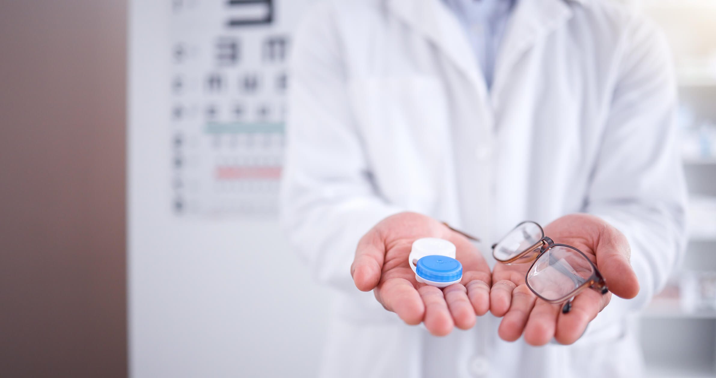 a doctor holding contact cases