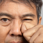 a man scratching his eye