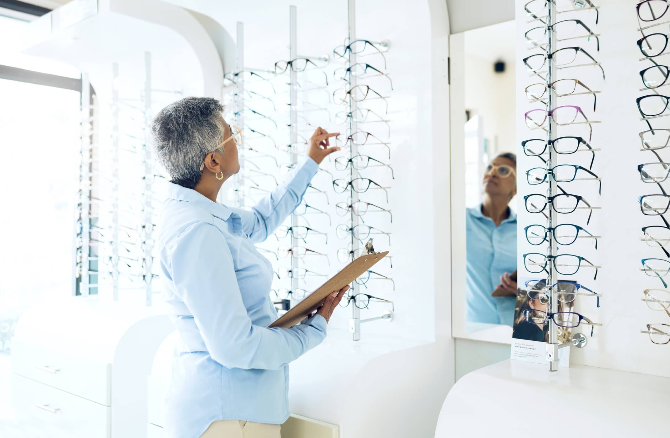 a woman picking out glasses